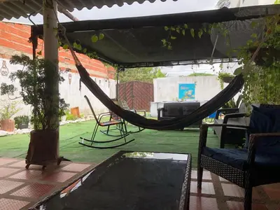a patio with a hammock and a pool at California House in Santa Veronica