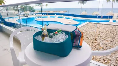 a cooler sitting on a table next to a pool at Magico Apartamento Frente al Mar 3 Habitaciones PAZ224 in Coveñitas