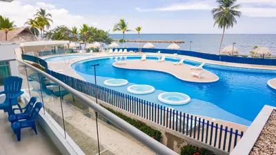 a resort swimming pool with a lazy river and the ocean at Magico Apartamento Frente al Mar 3 Habitaciones PAZ224 in Coveñitas