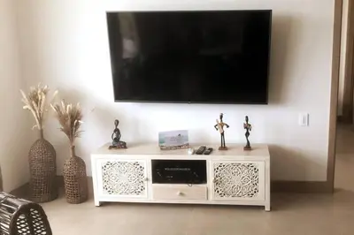 a white entertainment center with a flat screen tv on a wall at Apartamento de Lujo Morros Zóe - Manzanillo - Cartagena in Cartagena de Indias