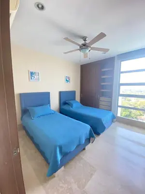 a bedroom with two beds and a ceiling fan at Las 4 Estaciones Alojamientos de Ensueño Coveñas in Coveñitas