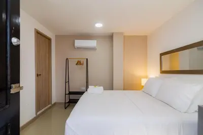 a bedroom with a large white bed in a room at Bahari Cartagena Suites in Cartagena de Indias