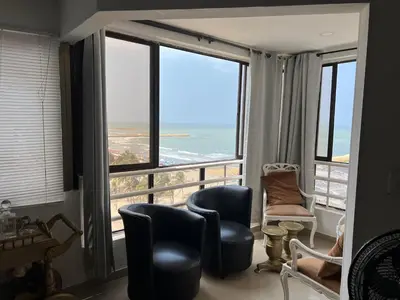 a room with chairs and a view of the ocean at Apartamento con vista al mar in Cartagena de Indias
