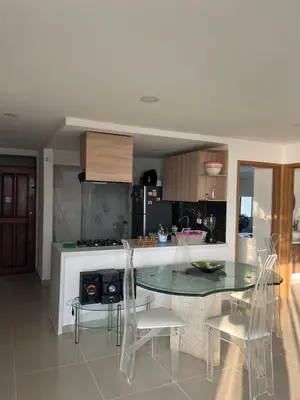 a kitchen with a glass table and chairs in it at Apartamento con vista al mar in Cartagena de Indias