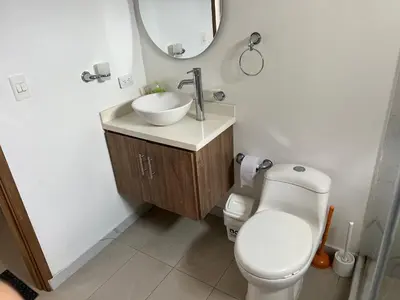 a bathroom with a toilet and a sink and a mirror at Apartamento con vista al mar in Cartagena de Indias