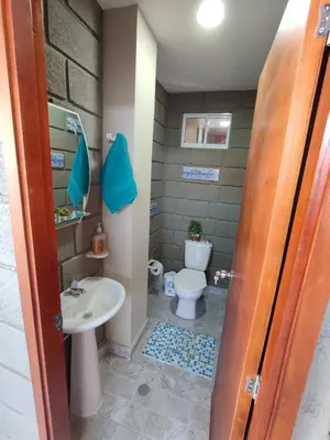 a bathroom with a toilet and a sink at Rancho Ayala II in Santa Marta