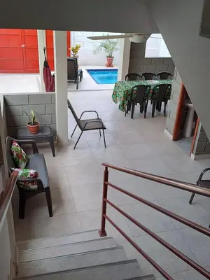 a patio with tables and chairs and a pool at Rancho Ayala II in Santa Marta