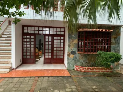 a house with two red doors and a porch at Cabaña #5 en Condominio Mar de Coveñas in Coveñas