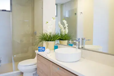 a bathroom with a sink and a toilet and a mirror at Apartamento vista al Mar lateral Panoramic View,Spectacular building,Pools, Beach Morros zoe ultimo piso in Cartagena de Indias