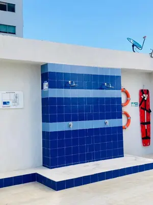 a blue tiled wall in a room with a red scarf at Apartamento 1804 Cartagena Bocagrande hermosa vista a 1 cuadra de la playa in Cartagena de Indias