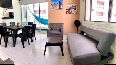 a living room with a couch and a table and chairs at Apartamento 1804 Cartagena Bocagrande hermosa vista a 1 cuadra de la playa in Cartagena de Indias
