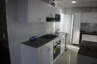 a kitchen with white cabinets and a counter top at Penthouses La Fe in Cartagena de Indias