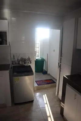 a kitchen with a sink and a refrigerator in a room at Penthouses La Fe in Cartagena de Indias