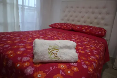 a bed with a pillow and a towel on it at Penthouses La Fe in Cartagena de Indias