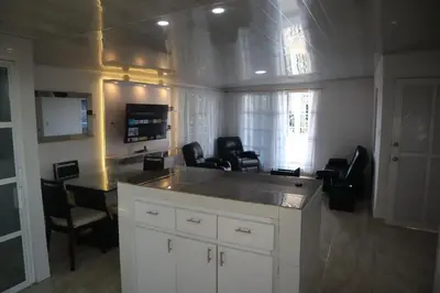 a room with a kitchen with chairs and a table at Penthouses La Fe in Cartagena de Indias
