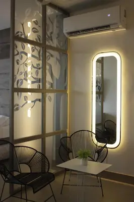 a room with chairs and a table and a mirror at Apartaestudio acceso al mar in Cartagena de Indias