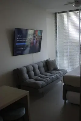 a living room with a couch and a picture on the wall at Apartaestudio acceso al mar in Cartagena de Indias
