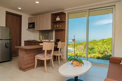 a kitchen with a table and chairs and a large window at Hotel Explore Caño Dulce in Tubará