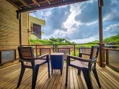 two chairs and a table on a deck with a view at Hotel Explore Caño Dulce in Tubará