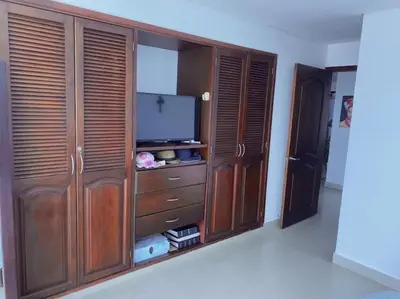 a large wooden entertainment center with a flat screen tv at Apartamento torres del lago 1102 in Cartagena de Indias