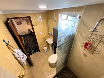 a small bathroom with a toilet and a shower at Cozy apt. on Manga Bay Blvd. (Apto. Bahia manga) in Cartagena de Indias