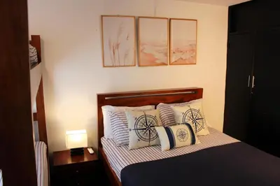 a bedroom with a bed with pillows with a bicycle on it at Cozy apt. on Manga Bay Blvd. (Apto. Bahia manga) in Cartagena de Indias