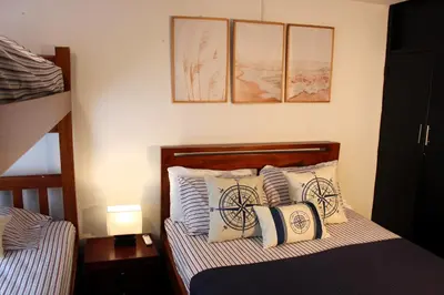 a small bedroom with a bed with pillows at Cozy apt. on Manga Bay Blvd. (Apto. Bahia manga) in Cartagena de Indias