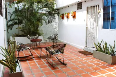 a patio with chairs and tables on a brick floor at Cozy apt. on Manga Bay Blvd. (Apto. Bahia manga) in Cartagena de Indias