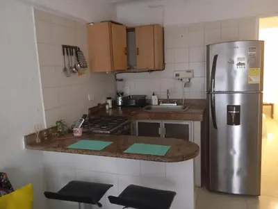 a kitchen with a stainless steel refrigerator and a counter at @casa__grace Apartaestudio en edificio al frente del mar!! in Cartagena de Indias
