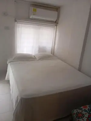a large white bed in a room with a window at @casa__grace Apartaestudio en edificio al frente del mar!! in Cartagena de Indias