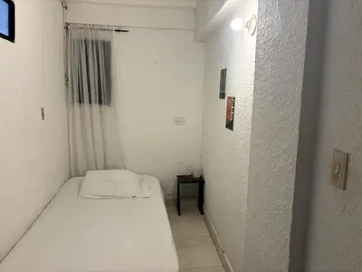 a small white room with a bed and a window at @casa__grace Apartaestudio en edificio al frente del mar!! in Cartagena de Indias