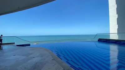 a swimming pool with a view of the ocean at TU VISTA IDEAL in Cartagena de Indias