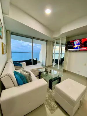 a living room with a white couch and a television at TU VISTA IDEAL in Cartagena de Indias
