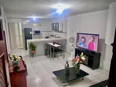 a living room with a television and a kitchen at Apartamento encanto in Cartagena de Indias