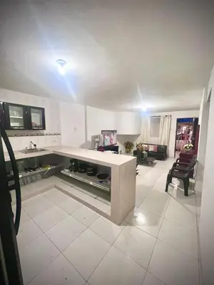 a kitchen with a counter and a living room at Apartamento encanto in Cartagena de Indias