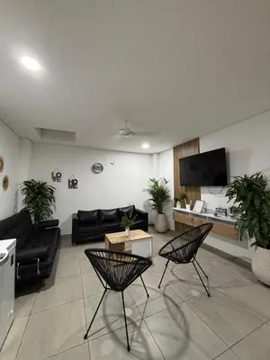 a living room with a couch and a table at Cabaña Milagro Bonito in Santa Marta