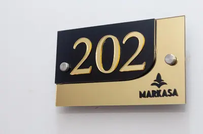 a black and gold sign with the number on it at Markasa Hotel boutique in Cartagena de Indias