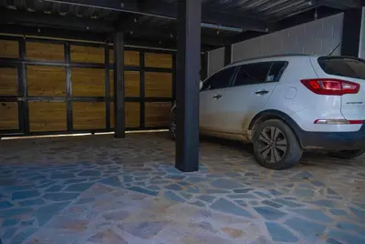 a white car is parked in a garage at COZY, Apartamento a solo 10 minutos Caminando a Playa Dormida, con Piscina y Parqueadero. in Santa Marta