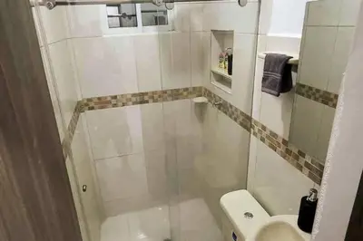 a small bathroom with a toilet and a sink at COZY, Apartamento a solo 10 minutos Caminando a Playa Dormida, con Piscina y Parqueadero. in Santa Marta
