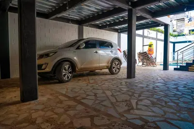 a silver car parked in a parking lot at COZY, Apartamento a solo 10 minutos Caminando a Playa Dormida, con Piscina y Parqueadero. in Santa Marta