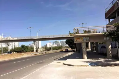 a bridge over a road with a highway at COZY, Apartamento a solo 10 minutos Caminando a Playa Dormida, con Piscina y Parqueadero. in Santa Marta