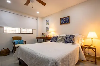 a bedroom with a bed and a table and a chair at Apartamento con salida a la playa in Santa Marta