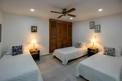 a bedroom with two beds and two lamps on tables at Apartamento con salida a la playa in Santa Marta