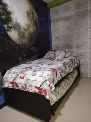 a bedroom with a bed with a painting on the wall at casa castillo san felipe in Cartagena de Indias