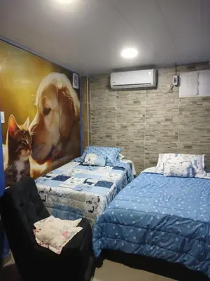a bedroom with two beds and a painting of a dog and a cat at casa castillo san felipe in Cartagena de Indias