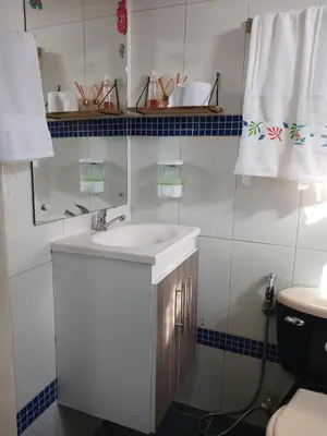 a bathroom with a sink and a mirror and a toilet at casa castillo san felipe in Cartagena de Indias