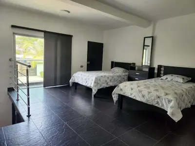 a room with two beds and a staircase in it at Cabaña los Abuelos in Coveñas