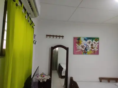 a hallway with green curtains and a mirror at Hospedaje Casa Pachi en Cartagena de Indias in Cartagena de Indias