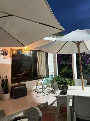 a patio with an umbrella and a table and chairs at Hospedaje Casa Pachi en Cartagena de Indias in Cartagena de Indias