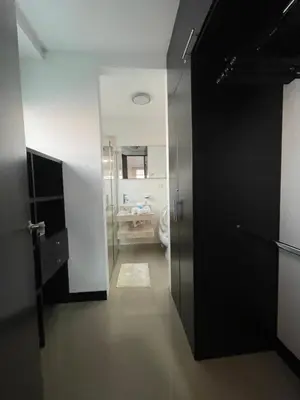 a bathroom with a black door and a bathroom with a sink at Atlantis Suites BAQ -Apartamento Moderno-2-BD in Barranquilla